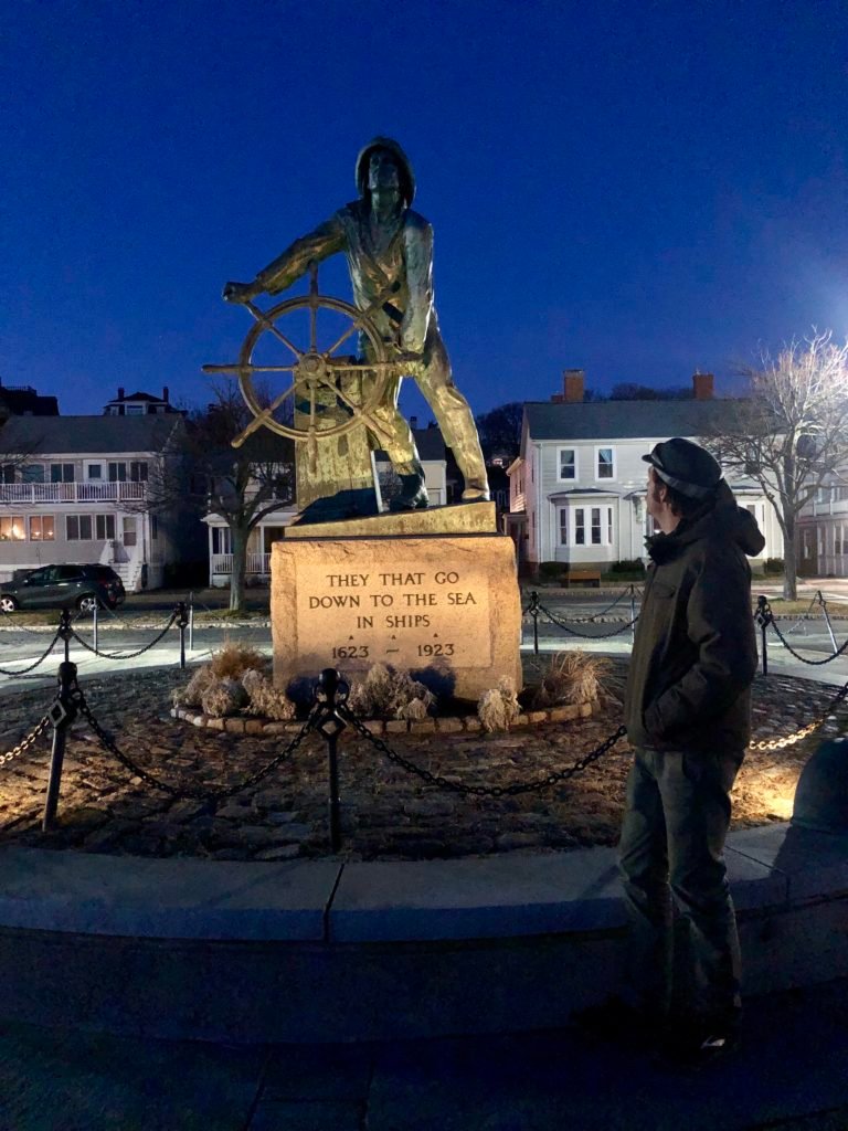 Gloucester fisherman statue at night