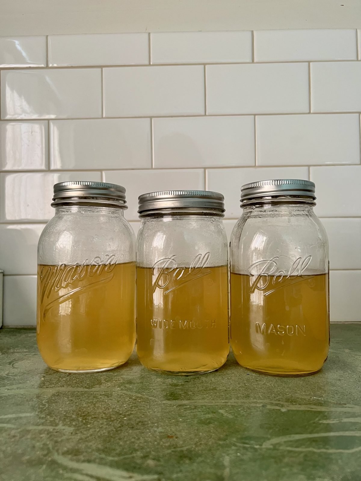 three mason jars of delicious homemade lobster stock