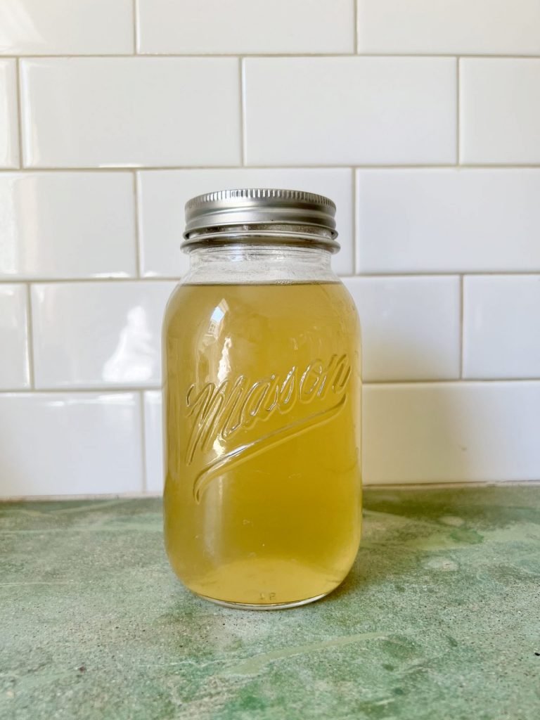 Mason jar full of homemade lobster stock