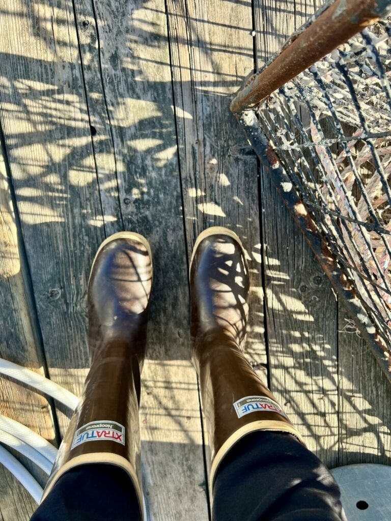 Megan Waldrep wearing legacy XTRATUF boots near a spiny lobster trap on a dock