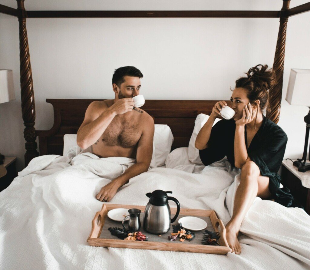 couple enjoying breakfast in bed